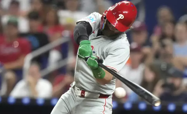 Philadelphia Phillies' Bryce Harper hits a single during the fifth inning of a baseball game against the Miami Marlins, Friday, Sept. 6, 2024, in Miami. (AP Photo/Lynne Sladky)