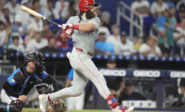 Philadelphia Phillies' Brandon Marsh follows through on a single during the sixth inning of a baseball game against the Miami Marlins, Sunday, Sept. 8, 2024, in Miami. (AP Photo/Lynne Sladky)