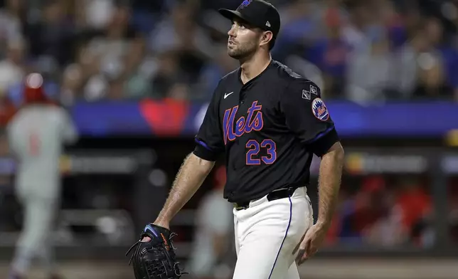 New York Mets starting pitcher David Peterson reacts walking to the dugout after being removed during the fourth inning of a baseball game against the Philadelphia Phillies, Friday, Sept. 20, 2024, in New York. (AP Photo/Adam Hunger)