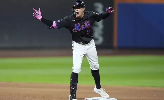 New York Mets' Brandon Nimmo (9) gestures to teammates after hitting an RBI double during the fourth inning of a baseball game against the Philadelphia Phillies, Thursday, Sept. 19, 2024, in New York. (AP Photo/Frank Franklin II)