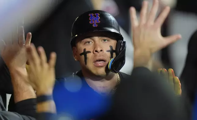 New York Mets' Francisco Alvarez celebrates with teammates after hitting a three-run home run during the fourth inning of a baseball game against the Philadelphia Phillies, Thursday, Sept. 19, 2024, in New York. (AP Photo/Frank Franklin II)