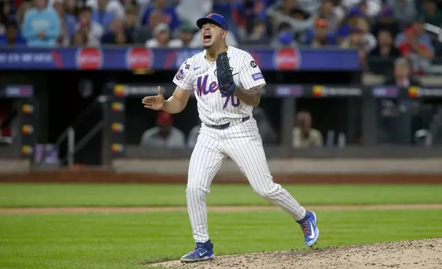 New York Mets relief pitcher Jose Butto reacts after striking out Philadelphia Phillies' Kody Clemens for the third out in the top of the seventh during a baseball game Sunday, Sept. 22, 2024, in New York. (AP Photo/John Munson)