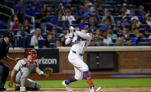 New York Mets' Brandon Nimmo follows through on his solo home run in the sixth inning during a baseball game against the Philadelphia Phillies, Sunday, Sept. 22, 2024, in New York. (AP Photo/John Munson)