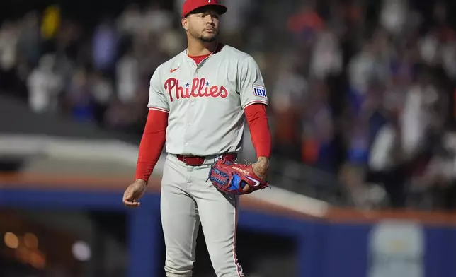 Philadelphia Phillies' Taijuan Walker reacts after New York Mets' Mark Vientos hit a home run during the first inning of a baseball game, Thursday, Sept. 19, 2024, in New York. (AP Photo/Frank Franklin II)