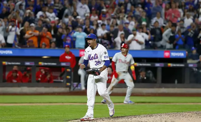 New York Mets relief pitcher Edwin Diaz (39) reacts after striking out Kody Clemens for the final out of a baseball game against the Philadelphia Phillies, Sunday, Sept. 22, 2024, in New York. (AP Photo/John Munson)