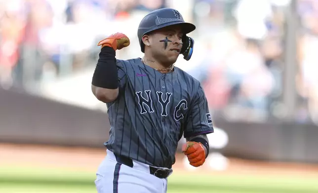 New York Mets' Francisco Alvarez reacts rounding the bases after hitting a home run against the Philadelphia Phillies during the second inning of a baseball game, Saturday, Sept. 21, 2024, in New York. (AP Photo/Noah K. Murray)