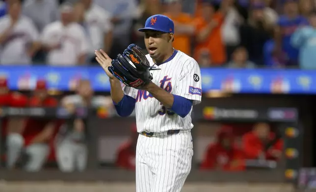 New York Mets relief pitcher Edwin Diaz reacts after getting Philadelphia Phillies' Alec Bohm to groundout to end the top of the eighth inning during a baseball game, Sunday, Sept. 22, 2024, in New York. (AP Photo/John Munson)