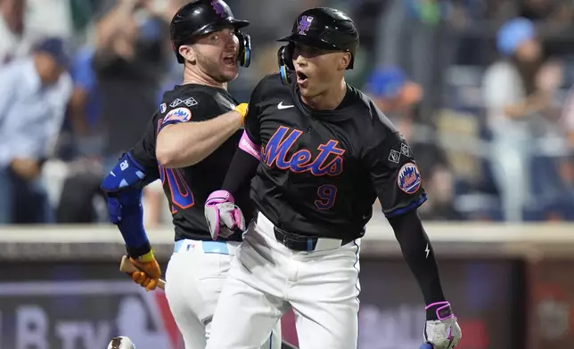 New York Mets' Brandon Nimmo (9) celebrates with Pete Alonso, left, after hitting a two-run home run during the third inning of a baseball game against the Philadelphia Phillies, Thursday, Sept. 19, 2024, in New York. (AP Photo/Frank Franklin II)