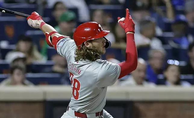 Philadelphia Phillies' Alec Bohm hits a three-run home run during the fourth inning of a baseball game against the New York Mets Friday, Sept. 20, 2024, in New York. (AP Photo/Adam Hunger)