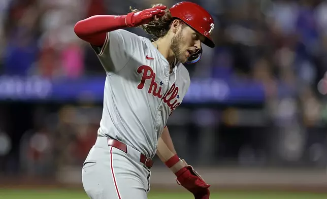 Philadelphia Phillies' Alec Bohm reacts after hitting a three-run home run during the fourth inning of a baseball game against the New York Mets Friday, Sept. 20, 2024, in New York. (AP Photo/Adam Hunger)