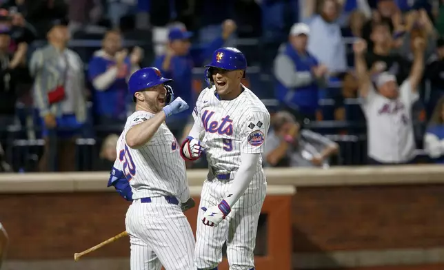 New York Mets' Pete Alonso, left, and Brandon Nimmo, right, celebrate after Nimmo's home run in the sixth inning during a baseball game against the Philadelphia Phillies, Sunday, Sept. 22, 2024, in New York. (AP Photo/John Munson)