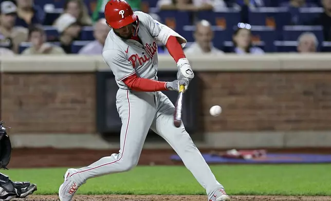 Philadelphia Phillies' Johan Rojas hits a two-run scoring ground rule double during the fourth inning of a baseball game against the New York Mets, Friday, Sept. 20, 2024, in New York. (AP Photo/Adam Hunger)