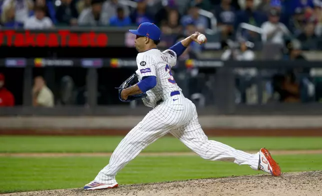 New York Mets relief pitcher Edwin Diaz delivers to the plate in the night inning during a baseball game against the Philadelphia Phillies, Sunday, Sept. 22, 2024, in New York. (AP Photo/John Munson)