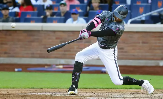 New York Mets' Brandon Nimmo hits a single during the seventh inning of a baseball game against the Philadelphia Phillies, Saturday, Sept. 21, 2024, in New York. (AP Photo/Noah K. Murray)