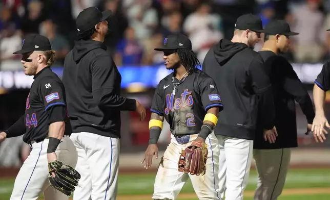 New York Mets' Luisangel Acuña, center, celebrates with teammates after a baseball game against the Philadelphia Phillies, Thursday, Sept. 19, 2024, in New York. (AP Photo/Frank Franklin II)