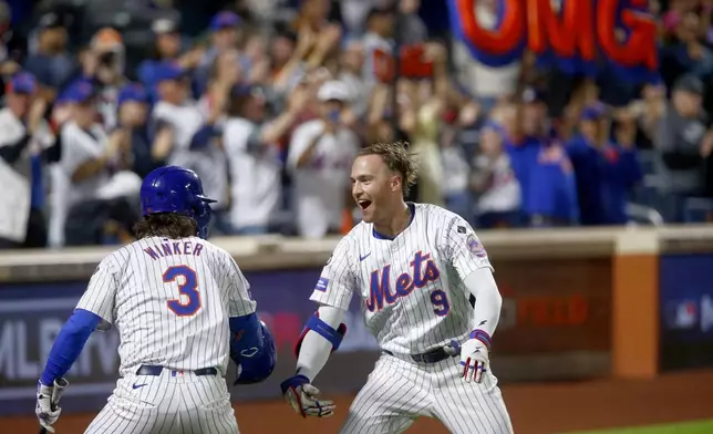 New York Mets' Jesse Winker, left, and Brandon Nimmo celebrate Nimmo's home run in the sixth inning during a baseball game Sunday, Sept. 22, 2024, in New York. (AP Photo/John Munson)