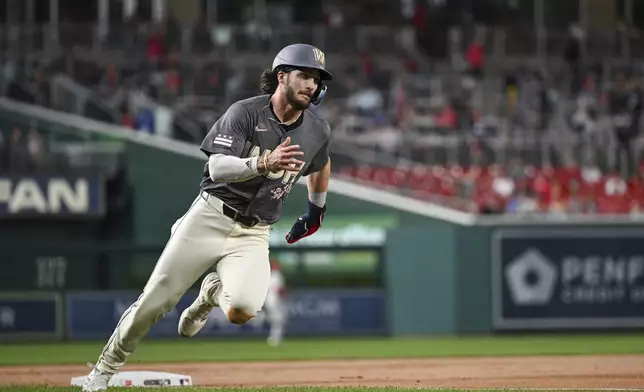 Washington Nationals' Dylan Crews runs to score on a single hit by Juan Yepez off Philadelphia Phillies pitcher Ranger Suárez during the first inning of a baseball game, Friday, Sept. 27, 2024, in Washington. (AP Photo/Terrance Williams)