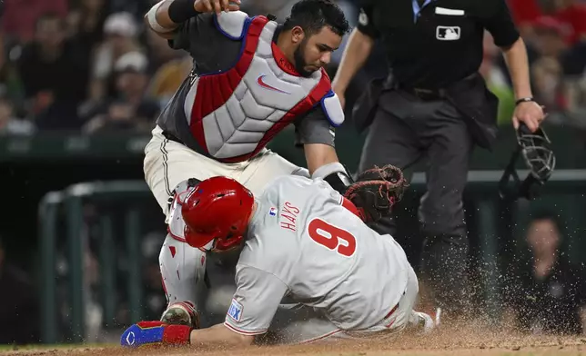 Philadelphia Phillies' Austin Hays (9) is tagged out by Washington Nationals catcher Keibert Ruiz while attempting to steal home during the third inning of a baseball game, Friday, Sept. 27, 2024, in Washington. (AP Photo/Terrance Williams)