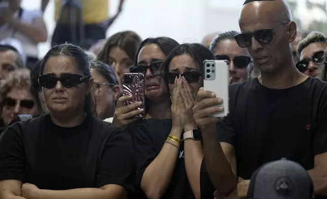 Mourners gather for the funeral of slain hostage Alexander Lobanov, who was killed in Hamas captivity in the Gaza Strip, in Ashkelon, southern Israel, Sunday, Sept. 1, 2024. (AP Photo/Tsafrir Abayov)