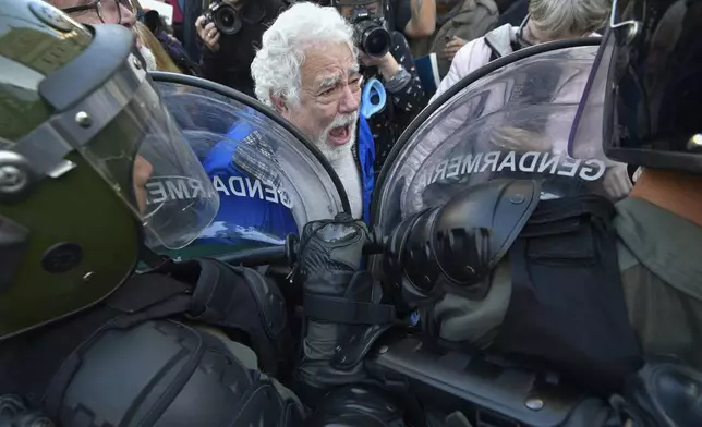 A retiree protests the presidential veto of a bill passed by Congress to raise pensions, in Buenos Aires, Argentina, Wednesday, Sept. 4, 2024. (AP Photo/Gustavo Garello)