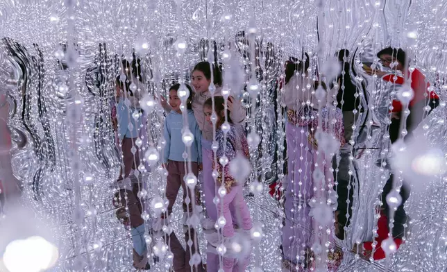 Children visit a Blow Up Experience installation, part of an exhibit of inflatable art and technology, in Montevideo, Uruguay, Friday, Aug. 30, 2024. (AP Photo/Matilde Campodonico)