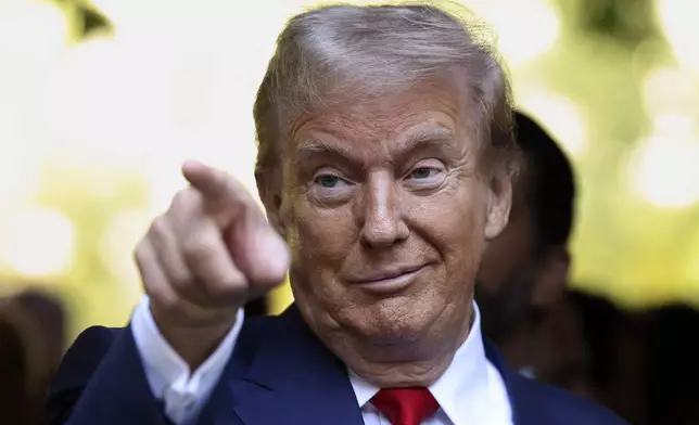 Republican presidential nominee former President Donald Trump motions while attending the 9/11 Memorial ceremony on the 23rd anniversary of the Sept. 11, 2001 terror attacks, Wednesday, Sept. 11, 2024, in New York. (AP Photo/Yuki Iwamura)