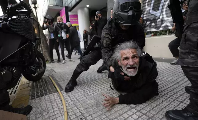 Police detain a protestor during a demonstration against President Javier Milei's veto of a pension raise in front of Congress in Buenos Aires, Argentina, Wednesday, Sept. 11, 2024. (AP Photo/Rodrigo Abd)