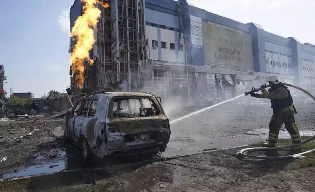 Firefighters extinguish the fire after a Russian missile attack in Kharkiv, Ukraine, Sunday, Sept. 1, 2024. (AP Photo/Andrii Marienko)