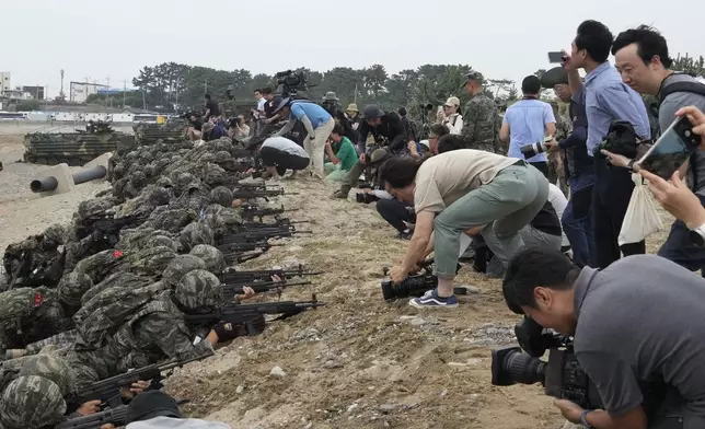 Medias film as South Korean Marines take positions after landing on the beach during the combined military amphibious landing exercise between South Korea and the U.S., called Ssangyong exercise, in Pohang, South Korea, Monday, Sept. 2, 2024. (AP Photo/Ahn Young-joon)