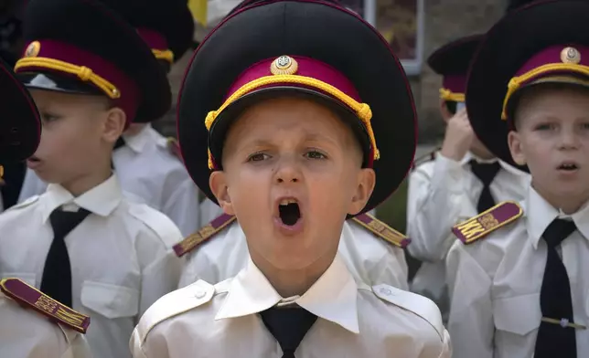 Cadets sing the national anthem on the first day at school in a cadet lyceum in Kyiv, Ukraine, Monday, Sept. 2, 2024. Children and students went to school despite the fact that Kyiv was hit by massive Russian missile barrage early in the morning, causing fires, damaged buildings and infrastructure objects. (AP Photo/Efrem Lukatsky)