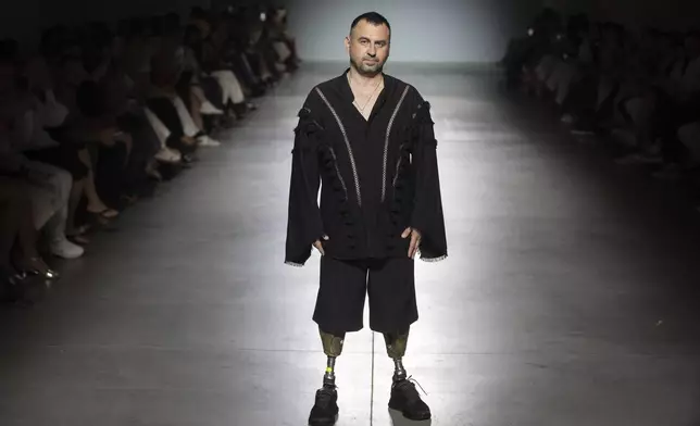 A Ukrainian war veteran wearing prosthetics takes to the runway to demonstrate outfit by designers Andreas Moskin and Andriy Bilous during Fashion Week show in Kyiv, Ukraine, Tuesday, Sept. 3, 2024. (AP Photo/Efrem Lukatsky)