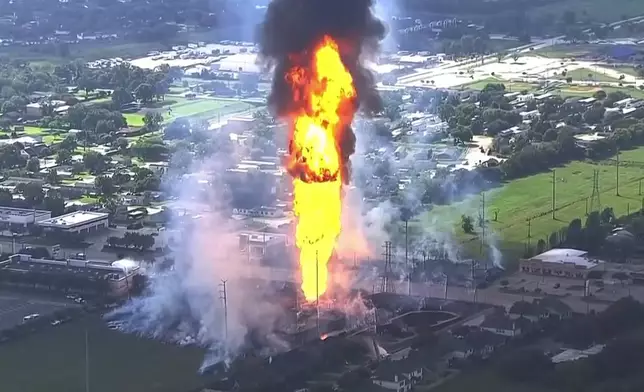 A pipeline fire in La Porte, Texas, sparks grass fires and burns power poles on Monday, Sept. 16, 2024, forcing people in the surrounding neighborhood to evacuate. (KTRK via AP)