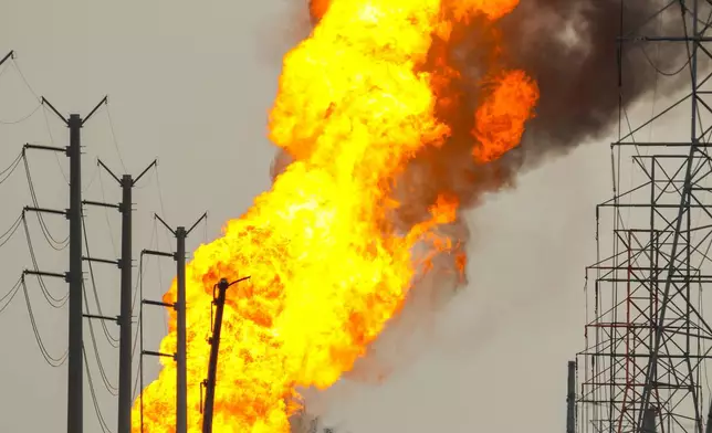 A pipeline carrying liquified natural gas burns near Spencer Highway and Summerton on Monday, Sept. 16, 2024, in La Porte, Texas. (Brett Coomer/Houston Chronicle via AP)