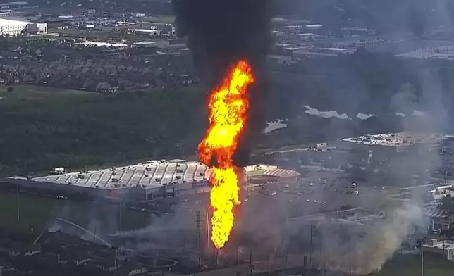 Firefighters work on the scene of a pipeline fire in La Porte, Texas, Monday, Sept. 16, 2024. (KTRK via AP)