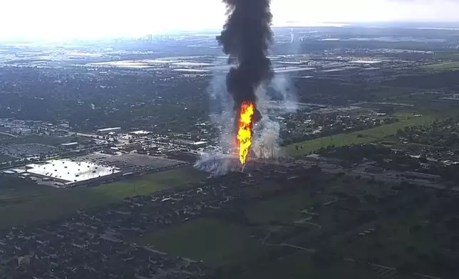 A pipeline fire in La Porte, Texas, sparks grass fires and burns power poles on Monday, Sept. 16, 2024, forcing people in the surrounding neighborhood to evacuate. (KTRK via AP)