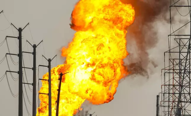 A pipeline carrying liquified natural gas burns near Spencer Highway and Summerton on Monday, Sept. 16, 2024, in La Porte, Texas. (Brett Coomer/Houston Chronicle via AP)