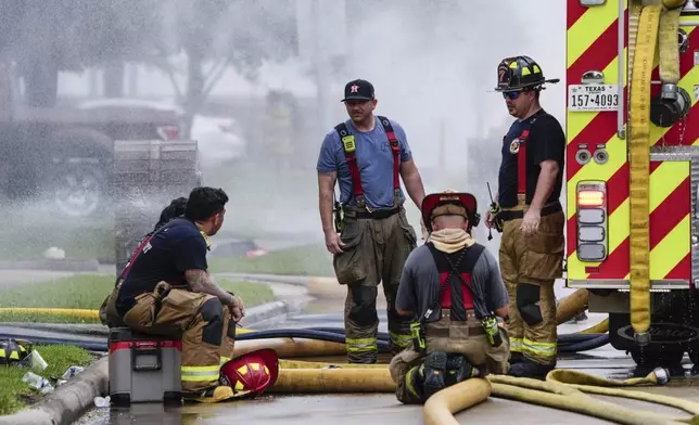 Firefighters take a break from battling a fire at a pipeline carrying liquified natural gas near Spencer Highway and Summerton on Monday, Sept. 16, 2024, in La Porte, Texas. (Brett Coomer/Houston Chronicle via AP)