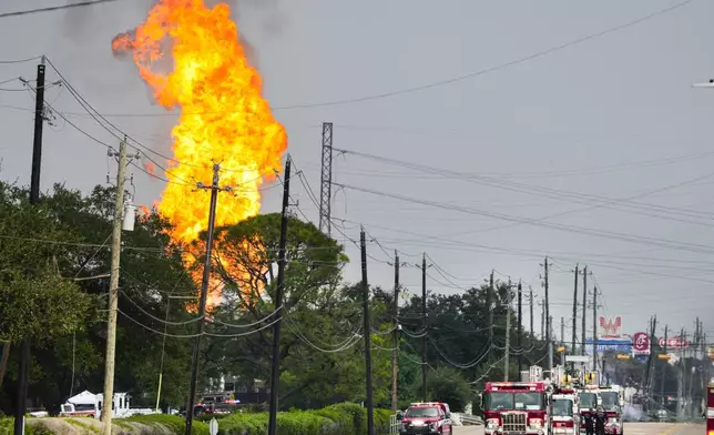 Emergency vehicles line Spencer Highway as firefighters respond to a massive burning pipeline fire near Spencer Highway and Summerton Monday, Sept. 16, 2024, in La Porte, Texas. (Brett Coomer/Houston Chronicle via AP)