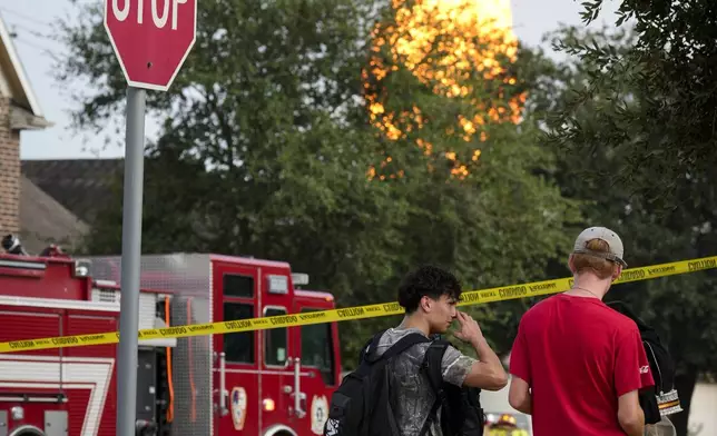 Residents watch the pipeline fire burning in La Porte, Texas, from South Meadow Drive and East Meadow Drive Monday, Sept. 16, 2024, in Deer Park, Texas. (Yi-Chin Lee/Houston Chronicle via AP)