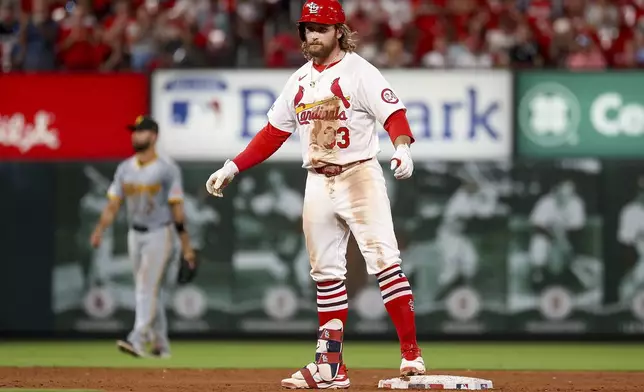 St. Louis Cardinals' Brendan Donovan, foreground, looks toward the dugout after hitting an RBI double during the sixth inning of a baseball game against the Pittsburgh Pirates, Thursday, Sept. 19, 2024, in St. Louis. (AP Photo/Scott Kane)