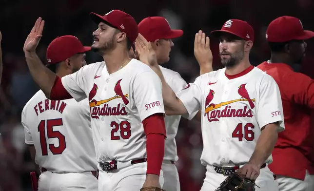 St. Louis Cardinals' Nolan Arenado (28) and Paul Goldschmidt (46) celebrate a 4-0 victory over the Pittsburgh Pirates following a baseball game Monday, Sept. 16, 2024, in St. Louis. (AP Photo/Jeff Roberson)