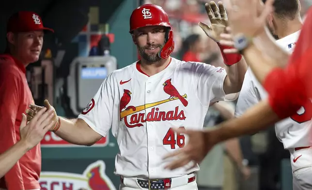 St. Louis Cardinals' Paul Goldschmidt, center, is congratulated by teammates after scoring during the fourth inning of a baseball game against the Pittsburgh Pirates, Thursday, Sept. 19, 2024, in St. Louis. (AP Photo/Scott Kane)