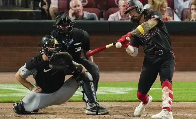 Cincinnati Reds' Jonathan India (6) hits a home run as Pittsburgh Pirates catcher Joey Bart (14) and home plate umpire Jordan Baker look on in the fourth inning of a baseball, Friday, Sept. 20, 2024, in Cincinnati. (AP Photo/Carolyn Kaster)