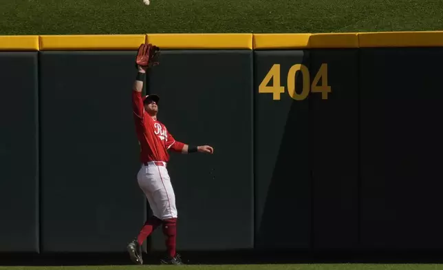 Cincinnati Reds center fielder TJ Friedl catches a fly ball hit by Pittsburgh Pirates' Oneil Cruz for the third out of the ninth inning of a baseball game, Saturday, Sept. 21, 2024, in Cincinnati. (AP Photo/Carolyn Kaster)