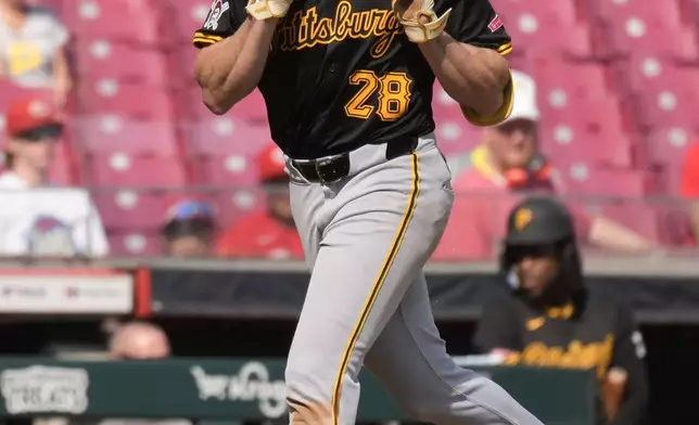 Pittsburgh Pirates' Billy Cook (28) looks to the sky as he rounds the bases after hitting a home run during the ninth inning of a baseball game against the Cincinnati Reds, Saturday, Sept. 21, 2024, in Cincinnati. The Reds won 7-1. (AP Photo/Carolyn Kaster)