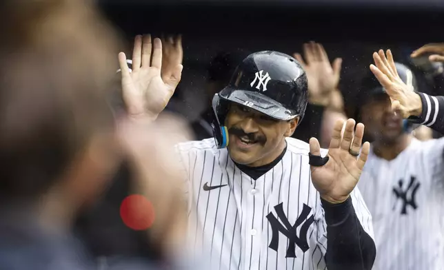 New York Yankees Trent Grisham, right celebrates his double home run with teammates at the dougout during the first inning of a baseball game against the Pittsburgh Pirates, Sunday, Sept. 29, 2024, in New York. (AP Photo/Eduardo Munoz Alvarez)