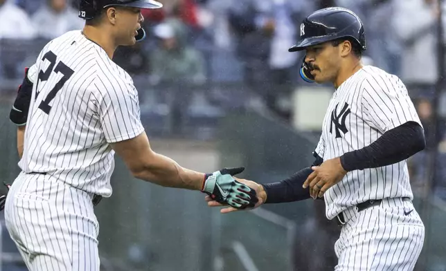 New York Yankees Trent Grisham, right, celebrates after his two-run home run with Giancarlo Stanton, left, during the first inning of a baseball game against the Pittsburgh Pirates, Sunday, Sept. 29, 2024, in New York. (AP Photo/Eduardo Munoz Alvarez)