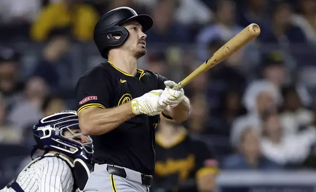 Pittsburgh Pirates' Bryan Reynolds, right, watches his two-run home run during the eighth inning of a baseball game against the New York Yankees, Friday, Sept. 27, 2024, in New York. (AP Photo/Adam Hunger)