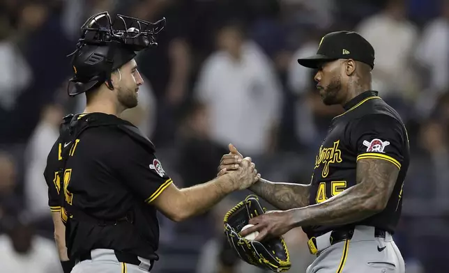 Pittsburgh Pirates relief pitcher Aroldis Chapman celebrates with catcher Joey Bart after the ninth inning of a baseball game against the New York Yankees, Friday, Sept. 27, 2024, in New York. The Pirates won 4-2. (AP Photo/Adam Hunger)