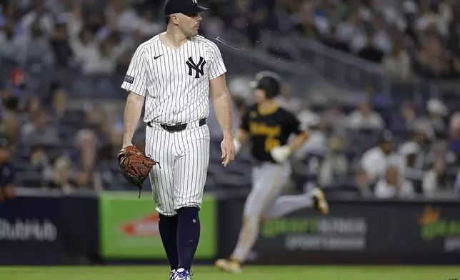 New York Yankees starting pitcher Carlos Rodon, foreground, reacts after giving up a home run to Pittsburgh Pirates' Bryan Reynolds during the sixth inning of a baseball game Friday, Sept. 27, 2024, in New York. (AP Photo/Adam Hunger)